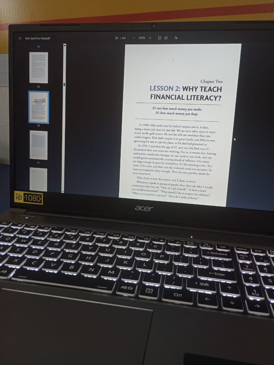 Rich Dad Poor Dad open on a laptop screen